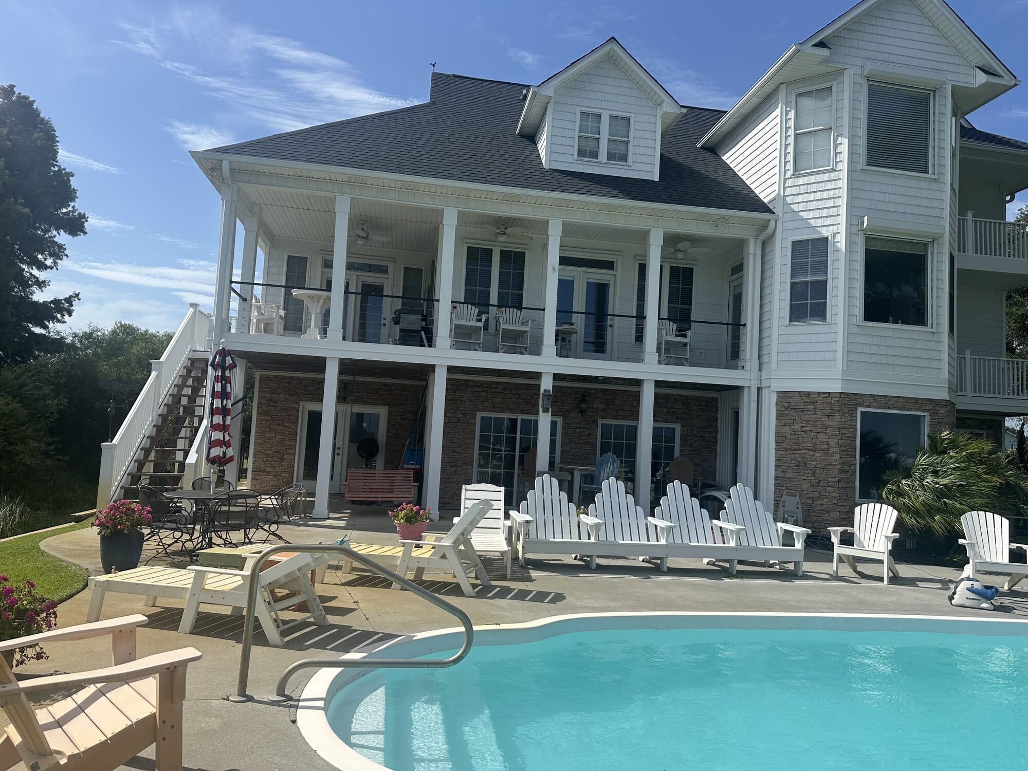 Two-story coastal home near Swansboro, NC with stainless cable railing on the second-story porch, installed by Jacksonville Fence Company